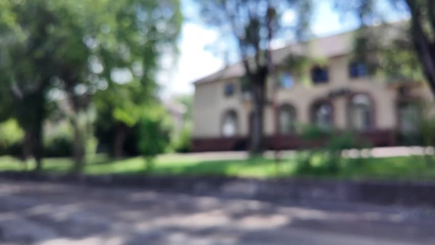 Blurred background city. Abstract city background. City streets and cars. Roads, houses and cars. Blurred video.