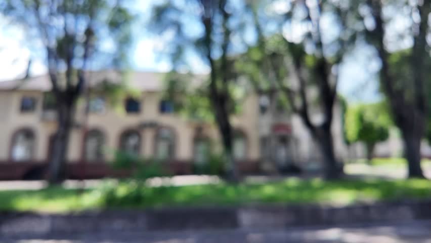 Blurred background city. Abstract city background. City streets and cars. Roads, houses and cars. Blurred video.