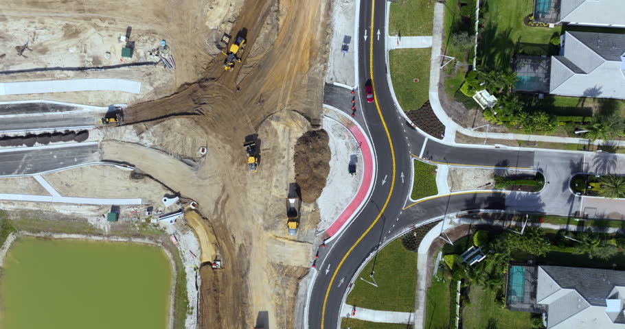 Roundabout construction roadworks on American transport infrastructure. Renovation of highway road with moving traffic. Development of interstate transportation concept.