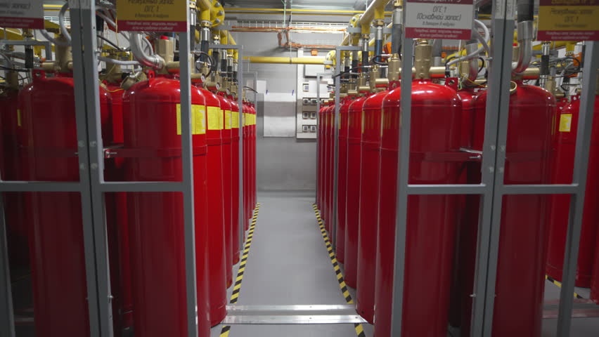 Gas cylinders connect to pipeline system enabling energy transfer inside technical zone. Bold mechanical connectors unify gas supply