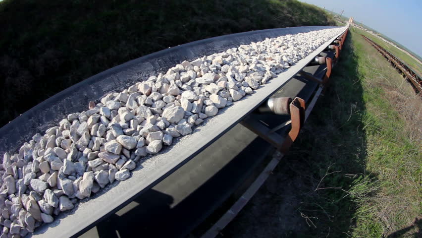 Fisheye of a long conveyor belt transporting stones to the manufacturing plant