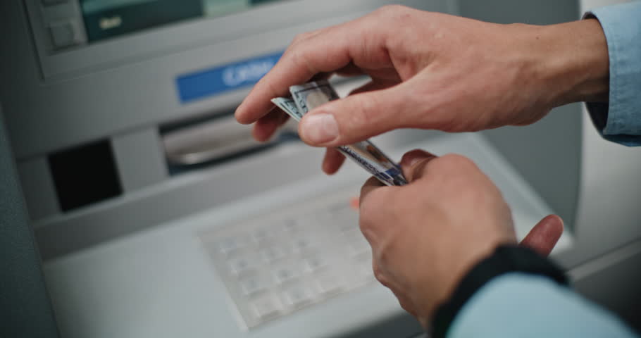 Close Up of Unrecognizable Man, Businessman Counting US Dollar Bills in Hands After Withdrawing Cash Money Operation from ATM Machine. Banking Services, Cash Withdrawal Systems, Financial Transactions