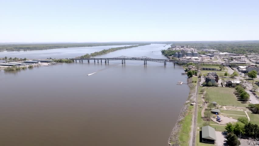 Decatur, Alabama bridge with boat on water with drone video moving over water and forward.