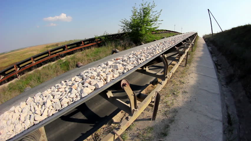 Fisheye of a long conveyor belt transporting stones to the manufacturing plant