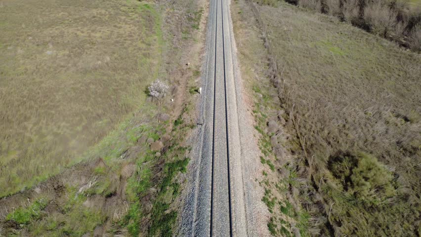 Empty railroad tracks crossing the countryside
