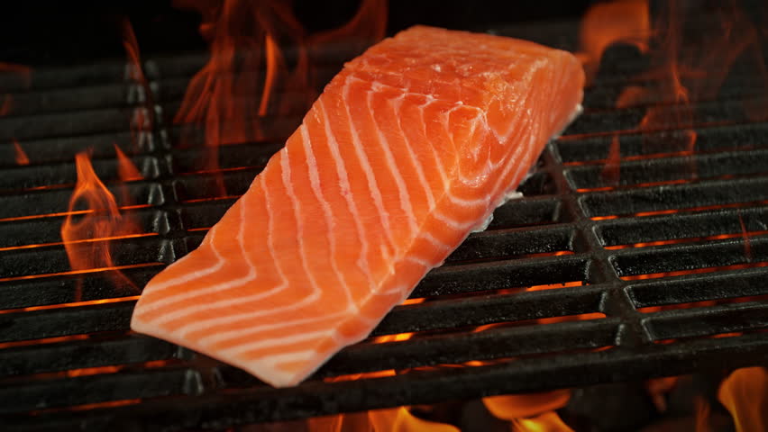 Super Slow Motion Shot of Salmon Filet on Fired Up Grill with Camera Motion at 1000fps.