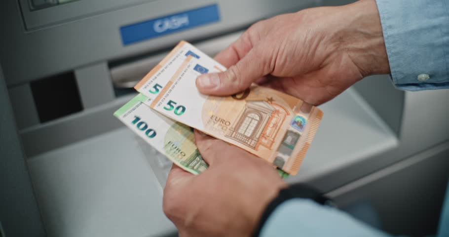 Close Up of Unrecognizable Man, Businessman Counting Euro Bills in Hands After Withdrawing Cash Money Transaction from ATM Machine. Banking Services, Cash Withdrawal Systems, Financial Operations.