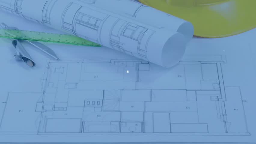 Unrolling blueprint set on drafting desk with ruler, compass, helmet and floating digital icons. Architecture, engineering, design, drafting, innovation, construction, blueprint