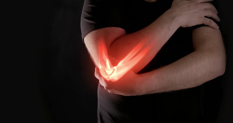 Man holding painful elbow with red glow indicating joint pain. Concept of inflammation, injury, or arthritis.