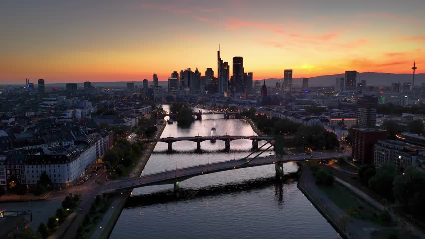 Aerial evening view of the illuminated skyline of Frankfurt, Germany, with River Main and the modern office skyscrapers of the city