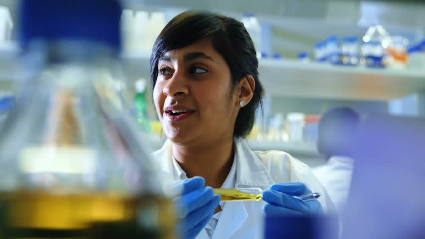 female researcher holding test tube while heart thumbs-up, user icons floating in lab research. Scientist, innovation, technology, analytics, healthcare, precision, science - Powered by Shutterstock - Get 15% off with code: PIKWIZARD15