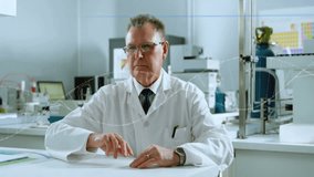 Senior researcher raising finger toward digital interface in science lab, highlighting data overlay. Scientist, innovation, technology, laboratory, analytical, research, futuristic - Powered by Shutterstock - Get 15% off with code: PIKWIZARD15