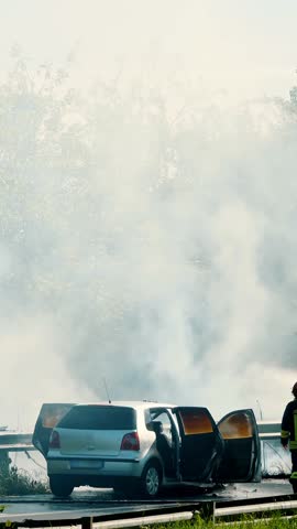 Emergency Response Team at Car Accident Scene with Smoke on Rural Highway