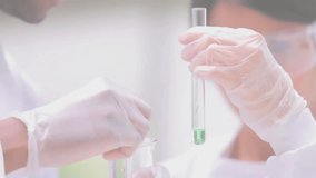 Lab technician holding test tube with pipette over beaker at lab, featuring heart balloons. Science, research, experimentation, laboratory, healthcare, innovation, sterile - Powered by Shutterstock - Get 15% off with code: PIKWIZARD15