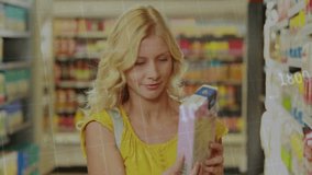 Female shopper examining product in grocery aisle, displaying animated yellow finance line charts. Retail, consumer, commerce, analytics, digital, data, shopping - Powered by Shutterstock - Get 15% off with code: PIKWIZARD15