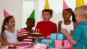 Boy blowing candles during business celebration, with animated confetti and gift icons. Festivities, celebration, joy, group, party, colorful, playful - Powered by Shutterstock - Get 15% off with code: PIKWIZARD15