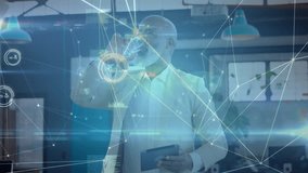 Senior male using tablet in business office, displaying data charts and network overlays. Professional, innovation, technology, connectivity, workspace, modern, analytics - Powered by Shutterstock - Get 15% off with code: PIKWIZARD15