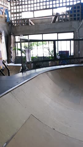 26 year old Brazilian girl in the bowl with a skate doing a Blunt_vertical.