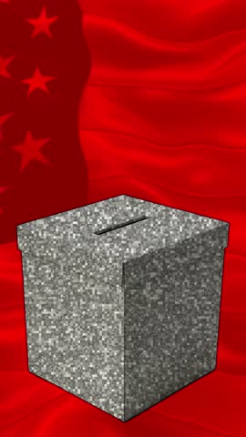 A hand is placing a ballot marked with 