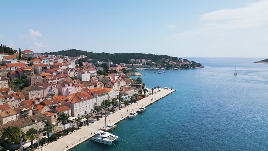 Hvar, Croatia from above with showing the rising rows of houses on a Spring day. Sailboats and yachts line the dock.