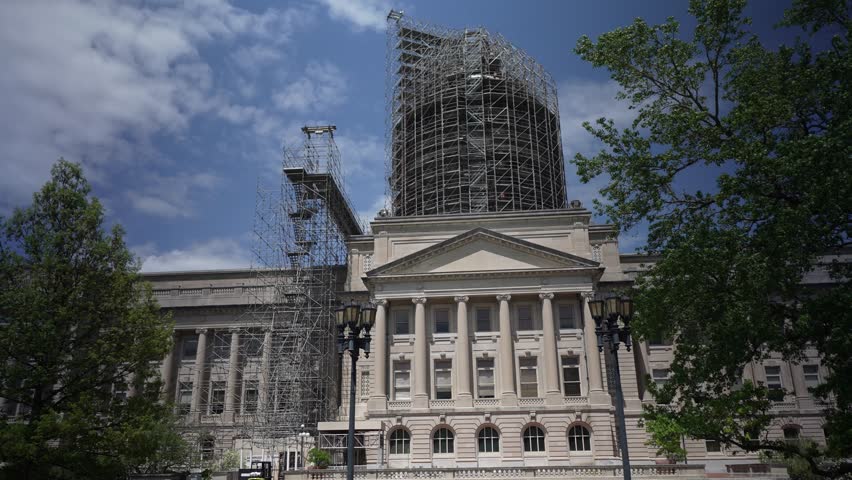 Renovation work is ongoing at the Kentucky State Capitol in Frankfort with scaffolding surrounding the dome. The historic building is a hub for government activities.
