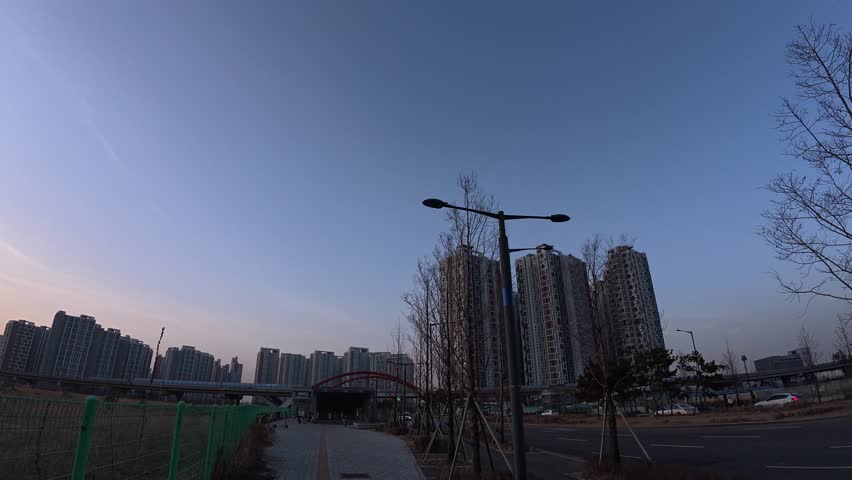 Strolling On Paved Walkway In Downtown Songdo At Dusk With View Of Apartment Buildings In Incheon, South Korea. POV