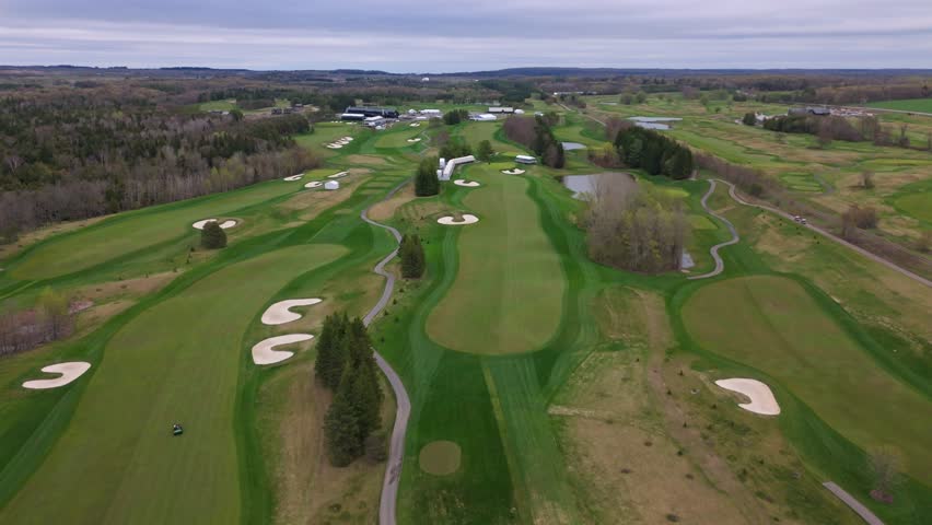 Aerial wide shot of TPC Toronto at Osprey Valley Golf Course In Alton Town, Caledon, Ontario, Canada. Neat grass and lawn of golf course. Wide shot.