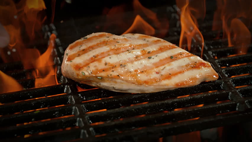 Super Slow Motion of Seasoning Falling on Chicken Breast on Grill with Camera Motion at 1000fps.