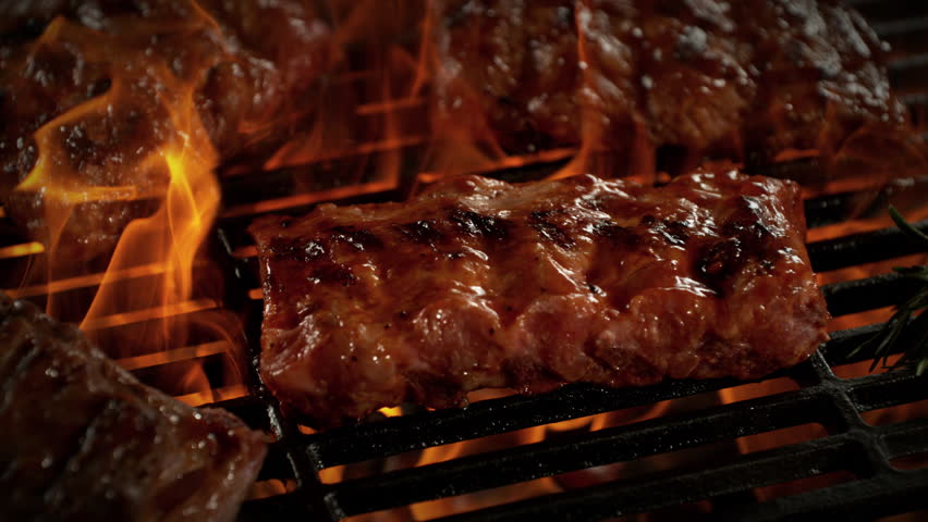 Super Slow Motion Shot of Pork Ribs on Fired Up Grill with Camera Motion at 1000fps.