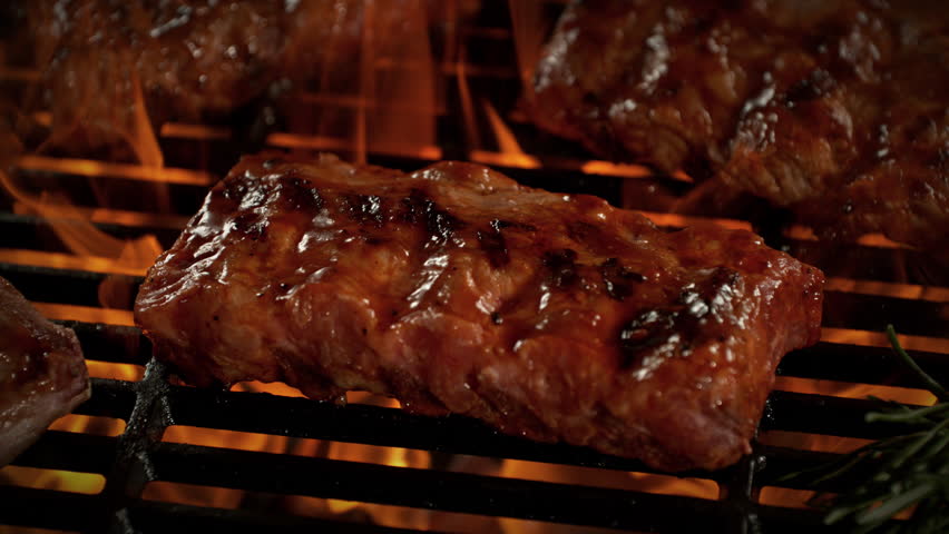 Super Slow Motion Shot of Pork Ribs on Fired Up Grill with Camera Motion at 1000fps.