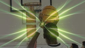 Male athlete raising arm reaching rim in gym, showing hoop with green ribbons for sports tech. Action, sports, fitness, energy, motion, vibrancy, athleticism - Powered by Shutterstock - Get 15% off with code: PIKWIZARD15