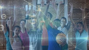 youth basketball team standing in gym, lifting silver trophy and raising fists with digital overlay. Athletes, victory, celebration, teamwork, achievement, competition, digital - Powered by Shutterstock - Get 15% off with code: PIKWIZARD15