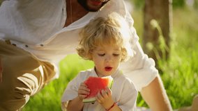 Father and son enjoy a sunny day with watermelon, A joyful moment of bonding outdoors in nature as a father and his child share a slice of fresh watermelon - Powered by Shutterstock - Get 15% off with code: PIKWIZARD15