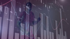 Mid adult man swinging in dark studio, with transparent candlestick bars and colored line graphs. Financial data, analytics, technology, investment, digital, futuristic, success - Powered by Shutterstock - Get 15% off with code: PIKWIZARD15