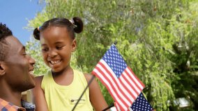 Father and daughter holding flags in yard, with animated powder particles scattering for marketing. Family, celebration, outdoor, vibrant, joyful, bonding, community - Powered by Shutterstock - Get 15% off with code: PIKWIZARD15
