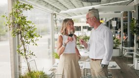 Senior couple tasting wine glasses at a modern restaurant - Powered by Shutterstock - Get 15% off with code: PIKWIZARD15