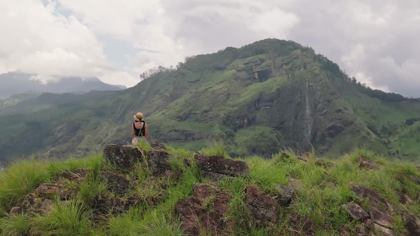 Woman Enjoying Panoramic View at Adams Peak  Hiking Adventure in Sri Lanka. Iconic hiking destination in Ella with stunning lush landscape views. Sri lanka island mountains.