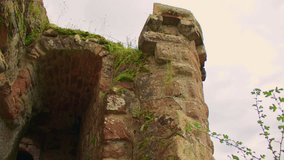 Overview of an entrance to a medieval castle, with arched ceilings and weathered stone walls. A close-up view of a medieval castle tower and stone archway leading into a dark passageway. - Powered by Shutterstock - Get 15% off with code: PIKWIZARD15