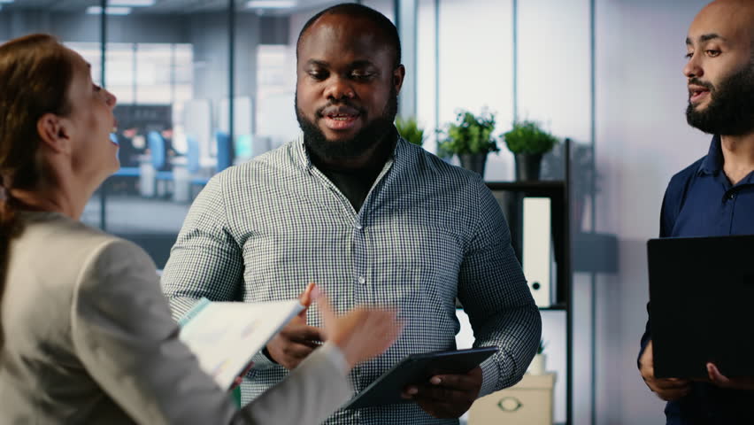 Business professionals shaking hands and reaching an agreement after the meeting, exchanging a handshake and giving their consent. CEOs making an alliance for global growth. Camera B.