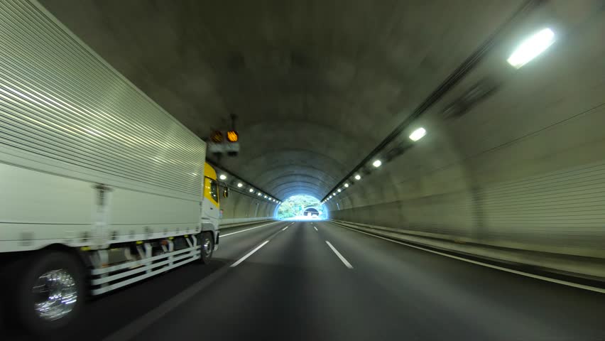 A timelapse of pov during car driving on the highway tunnel in Japan in fall weather