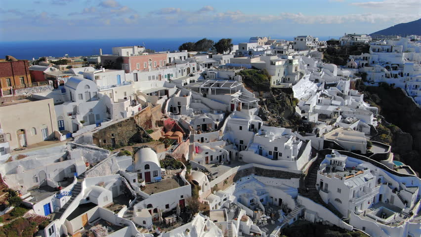 Explore stunning aerial views of Santorini island Greece, a renowned tourist destination in Greece famous for its iconic white architecture and breathtaking coastline, capturing Mediterranean beauty
