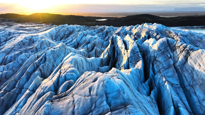 Aerial view of the beautiful Vatnajokull glacier in summer on a sunny day. Breathtaking view of the tongue of the Svinafellsjokull glacier and the surrounding volcanic mountains in Iceland. 