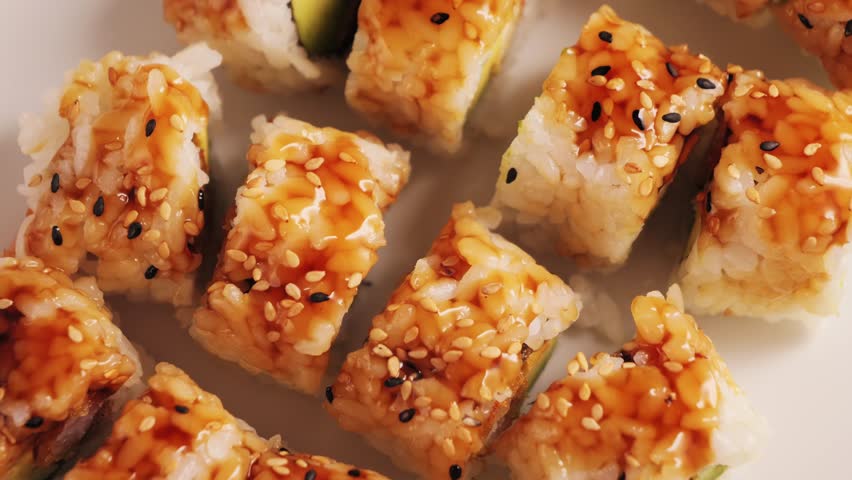 A set of sushi rolls with spicy sauce and shrimps tempura. Tempura rolls on a plate. High quality 4k footage