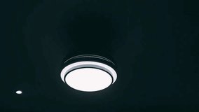 Ceiling lamp light on and hanging in a room. electrical appliances 4k video footage. - Powered by Shutterstock - Get 15% off with code: PIKWIZARD15