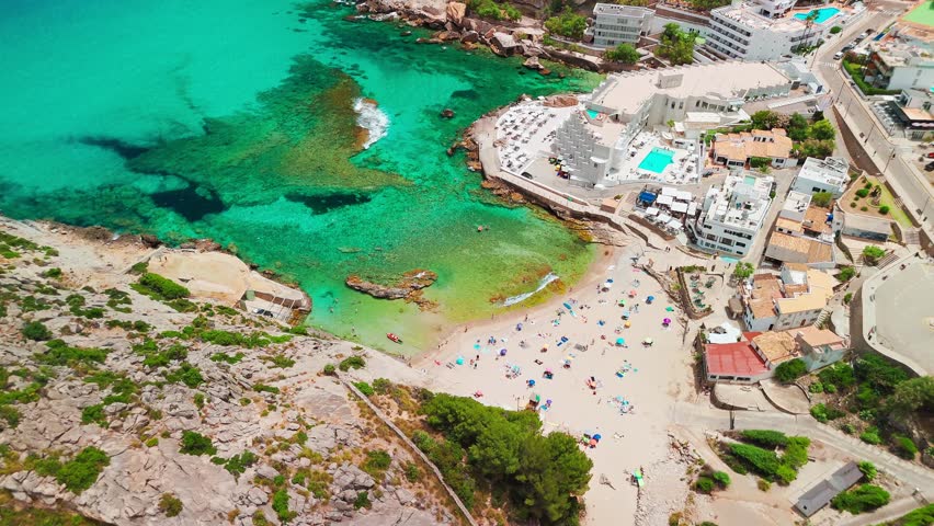 Aerial view of Cala Sant Vicent resort in Mallorca, Balearic Islands, Spain. Stunning sandy beach with turquoise waters, a popular holiday destination on Majorca island.