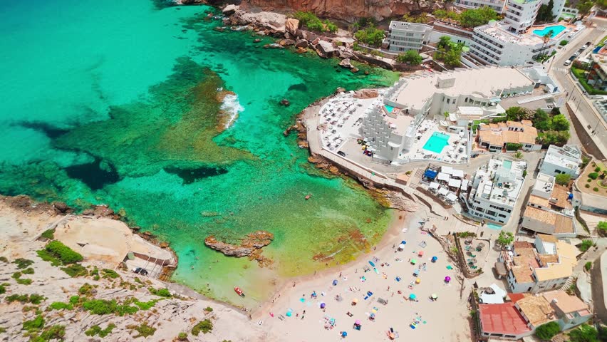 Aerial view of Cala Sant Vicent resort in Mallorca, Balearic Islands, Spain. Stunning sandy beach with turquoise waters, a popular holiday destination on Majorca island.