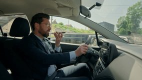 Stressed guy driver electric car driving road city angry man businessman male drive talk mobile phone smartphone inside automobile trip transport dissatisfied record voice mail message speakerphone - Powered by Shutterstock - Get 15% off with code: PIKWIZARD15