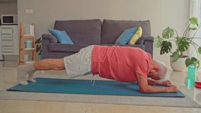 Video of Senior man doing plank exercise on fitness mat at home - Powered by Shutterstock - Get 15% off with code: PIKWIZARD15
