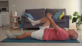 Video of elderly man doing legs stretching exercises on yoga mat at home - Powered by Shutterstock - Get 15% off with code: PIKWIZARD15