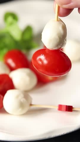 Caprese canape tomato and mozzarella, basil appetizer vegetable salad fresh tasty gourmet food background on the table rustic food top view copy space keto and paleo diet vegetarian food